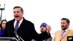 FILE - Matt Zeller of Iraq and Afghanistan Veterans of America, left, and veterans, refugee advocates and Afghan evacuees speak during a press conference to urge members of Congress to pass an Afghan adjustment act, in Washington, Feb. 14, 2022.