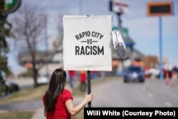 Native American woman participating in NDN Collective protest against racist businesses in Rapid City, S.D., April 20, 2022.