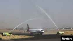 A Yemen Airways plane is greeted with water canon salute at Sanaa Airport as the first commercial flight in around six years, in Sanaa, Yemen, May 16, 2022.