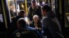 A woman who fled from the Azovstal steel plant in Mariupol is helped from a bus upon her arrival at a reception center for displaced people in Zaporizhzhia, Ukraine, May 8, 2022. 