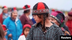 FILE - Innu women and children in traditional garb take part in a round dance at Gull Island, Labrador, Canada, Sept. 29, 2021. The Indigenous group inhabits territory in the northeastern portion of the present-day province of Labrador and some portions of Quebec.
