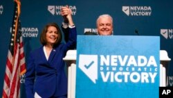 Sen. Catherine Cortez Masto, D-Nev., left, reacts alongside Nevada Gov. Steve Sisolak during an election night party hosted by the Nevada Democratic Party, Nov. 8, 2022, in Las Vegas. 