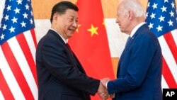 U.S. President Joe Biden, right, and Chinese President Xi Jinping shake hands before a meeting on the sidelines of the G-20 summit meeting, in Bali, Indonesia, Nov. 14, 2022.