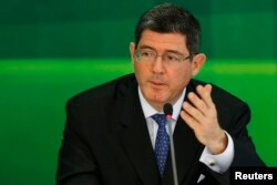FILE - Brazil's incoming finance minister, banker Joaquim Levy gestures during a news conference in Brasilia, Nov. 27, 2014.