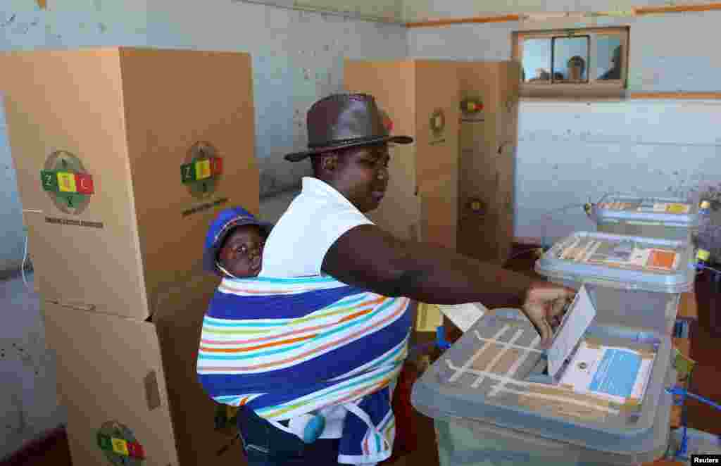 A woman with a baby on her back casts her ballot in the country&#39;s general elections in Harare, Zimbabwe, July 30, 2018.