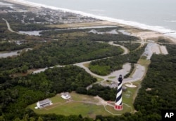 The Cape Hatteras lighthouse sits way off the beach in Buxton, N.C., Sept. 15, 2018. It was moved 2,900 feet inland in 1999.