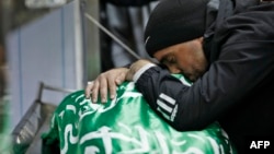 A Palestinian man mourns over the body of a youth killed during clashes with Israeli forces on Dec. 22, 2022, in the city of Nablus in the occupied West Bank. 