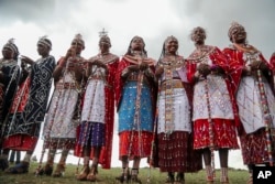 Maasai women spectators watch the Maasai Olympics in Kimana Sanctuary, southern Kenya Saturday, Dec. 10, 2022. (AP Photo/Brian Inganga)
