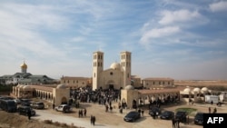 Catholic pilgrims attend a mass at the Church of the Baptism of Christ, near the site of Al-Maghtas, where Jesus is believed by Christians to have been baptised by Saint John, in the Jordan river valley, Jan. 13, 2023.
