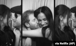 This image released by Netflix shows Prince Harry and Meghan, Duke and Duchess of Sussex, in a scene from the upcoming documentary "Harry & Meghan," directed by Liz Garbus. (Netflix via AP)