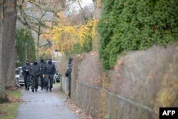 Police officers are seen during a raid on Dec. 7, 2022 in Berlin that is part of nationwide early morning raids against members of a far-right 'terror group' suspected of planning an attack.