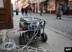 A portable generator sits outside a store during a power outage following Russian missile strikes on the Ukrainian city of Lviv, Dec. 29, 2022.