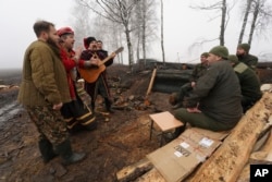 Artists perform for Ukraine's National Guard soldiers to mark Christmas close to the Russian border near Kharkiv, Ukraine,