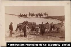 Army contractors and soldiers gathering the dead at the Wounded Knee massacre site, early January, 1891.
