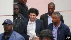 FTX founder Sam Bankman-Fried, center, is escorted from the Magistrate Court in Nassau, Bahamas, Dec. 21, 2022, after agreeing to be extradited to the U.S.