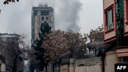 Smoke rises from a site of an attack at Shar-e Naw which is city's one of main commercial areas in Kabul, Dec. 12, 2022.