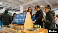 A vendor demonstrates a cannabis vending kiosk to attendees at The Bronx Dispensary Showroom in The Bronx Borough of New York City, U.S., December 9, 2022. REUTERS/David 'Dee' Delgado