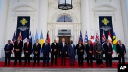 FILE - President Joe Biden, center, poses for a photo with Pacific Island leaders on the North Portico of the White House in Washington, Sept. 29, 2022.