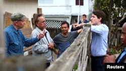 Perdana Menteri Kanada Justin Trudeau (kanan) berbicara dengan sejumlah warga di Vancouver, Kanada, pada 24 Mei 2022. (Foto: Reuters/Jesse Winter)