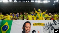 Brazil fans cheer by a banner celebrating Pele before the World Cup match between Brazil and South Korea at Al Rayyan, Qatar, Dec. 5, 2022. Pele led Brazil to victory in the 1958, 1962 and 1970 World Cups. 