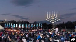 Attorney General Merrick Garland accompanied by Rabbi Levi Shemtov, speaks during the annual National Menorah Lighting in celebration of Hanukkah, on the Ellipse near the White House in Washington, Dec. 18, 2022. 