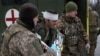 Ukrainian Army medics evacuate a wounded soldier not far from Soledar, Donetsk region, Jan. 14, 2023.