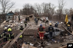 FILE - Emergency workers remove debris of a house destroyed following a Russian missile strike in Kyiv, Ukraine, Thursday, Dec. 29, 2022. (AP Photo/Roman Hrytsyna)