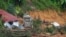 FILE - Rescue teams search for victims caught in a landslide in Batang Kali, Malaysia, Dec. 17, 2022.