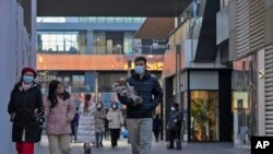 مردم در حال قدم زدن در پکن به دنبال بازگشایی بازارها