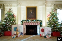The State Dining Room of the White House is decorated for the holiday season during a press preview of holiday decorations at the White House, Nov. 28, 2022, in Washington.