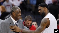FILE - Then-Miami Heat's LeBron James, right, jokes with Charlotte Bobcats coach Paul Silas, after an NBA basketball game in Charlotte, N.C., Jan. 3, 2011.