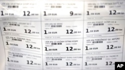 FILE - Prices of various books are displayed in both euro and kuna currencies in Zagreb, Croatia, Dec. 14, 2022. 