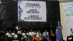 FILE - Malian nationals and young Ivorians gather to demand the release of 46 Ivorian soldiers being held by authorities in Mali, in the Abobo suburb of Abidjan, Ivory Coast, on Sept. 20, 2022. 