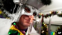 Members of the Mardi Gras group The Phunny Phorty Phellows revel on a street car for their annual kick off of the Mardi Gras season on Twelfth Night in New Orleans, Jan. 6, 2023.