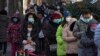 Residents line up in freezing temperatures for their routine COVID-19 throat swabs at a coronavirus testing site in Beijing, China, Dec. 4, 2022.