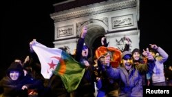Fans with Moroccan, right, and Algerian flags gather in Paris, France, for the Morocco v Portugal match at the World Cup in Qatar, Dec. 10, 2022.