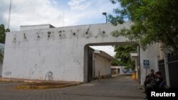 Police sit outside the facilities of La Prensa newspaper, a long-standing newspaper critical of President Daniel Ortega, after the Nicaraguan government took over the facilities to turn the space into a "cultural center," in Managua, Nicaragua Aug. 23, 2022.