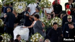 Pele's daughter, Kelly Cristina Nascimento, is seen next to the body of Brazilian soccer legend Pele in his casket, as he lays in state on the pitch of his former club Santos' Vila Belmiro Stadium in Santos, Jan. 2, 2023.