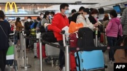 Passengers queue to check-in at the international airport in Hong Kong on Dec. 28, 2022. 