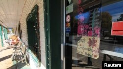 FILE - A "We're Hiring!" sign advertises job openings at a bakery in Old Chelsea village, Quebec, Canada, Oct. 3, 2022. Canada’s eagerness for new immigrants is partly driven by an acute labor shortage attributed in part to a rapidly aging population.