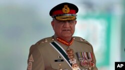 FILE - Pakistan's Army Chief General Qamar Javed Bajwa arrives for a military parade to mark Pakistan National Day in Islamabad, Pakistan, March 23, 2022.