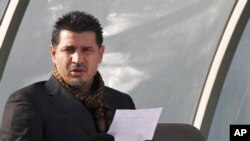 FILE - Former Iran's national soccer team coach Ali Daei before a match in Tehran, Jan. 14, 2009. Daei says his wife and daughter departed from Tehran, legally before the flight made an unannounced stop on Kish Island in the Persian Gulf, where they were questioned.