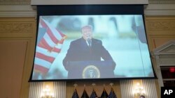 A video presentation plays as the House select committee investigating the Jan. 6 attack on the US Capitol holds its final meeting on Capitol Hill, Dec. 19, 2022. 