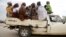 FILE - Women travel in the back of a truck in the town of Mararaba after the Nigerian military recaptured it from Boko Haram, in Adamawa state, May 10, 2015.