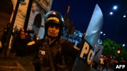 Riot police clash with supporters of former President Pedro Castillo during a protest to demand the closure of Congress and the release of Castillo in downtown Lima, on Dec. 15, 2022. 