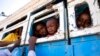 FILE - Refugees who fled the conflict in Ethiopia's Tigray region ride a bus going to the Village 8 temporary shelter, near the Sudan-Ethiopia border, in Hamdayet, eastern Sudan on Dec. 1, 2020.