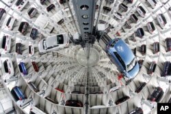 FILE - Volkswagen cars are presented to media inside a delivery tower prior to the company's annual press conference in Wolfburg, Germany, April 28, 2016.