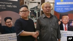 Le Phuc Hai, 66 and To Gia Huy, 9, pose for a photo after having Trump and Kim haircuts in Hanoi, Vietnam, Feb. 19, 2019. U.S. President Donald Trump and North Korean leader Kim Jong Un have become style icons in Hanoi, a week before their second summit there.