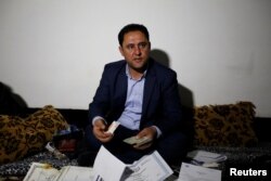 Botan Mahmoud Hassour shows his identity cards when he was working with the U.S. military as he awaits his date of travel to the U.S. as a refugee after U.S. President Donald Trump's decision to temporarily bar travelers from seven countries, in Erbil, Iraq, Jan. 28, 2017.