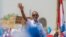 Rwandan President Paul Kagame of the ruling Rwandan Patriotic Front (RPF) waves to his supporters during his final campaign rally in Kigali, Rwanda, Aug. 2, 2017.